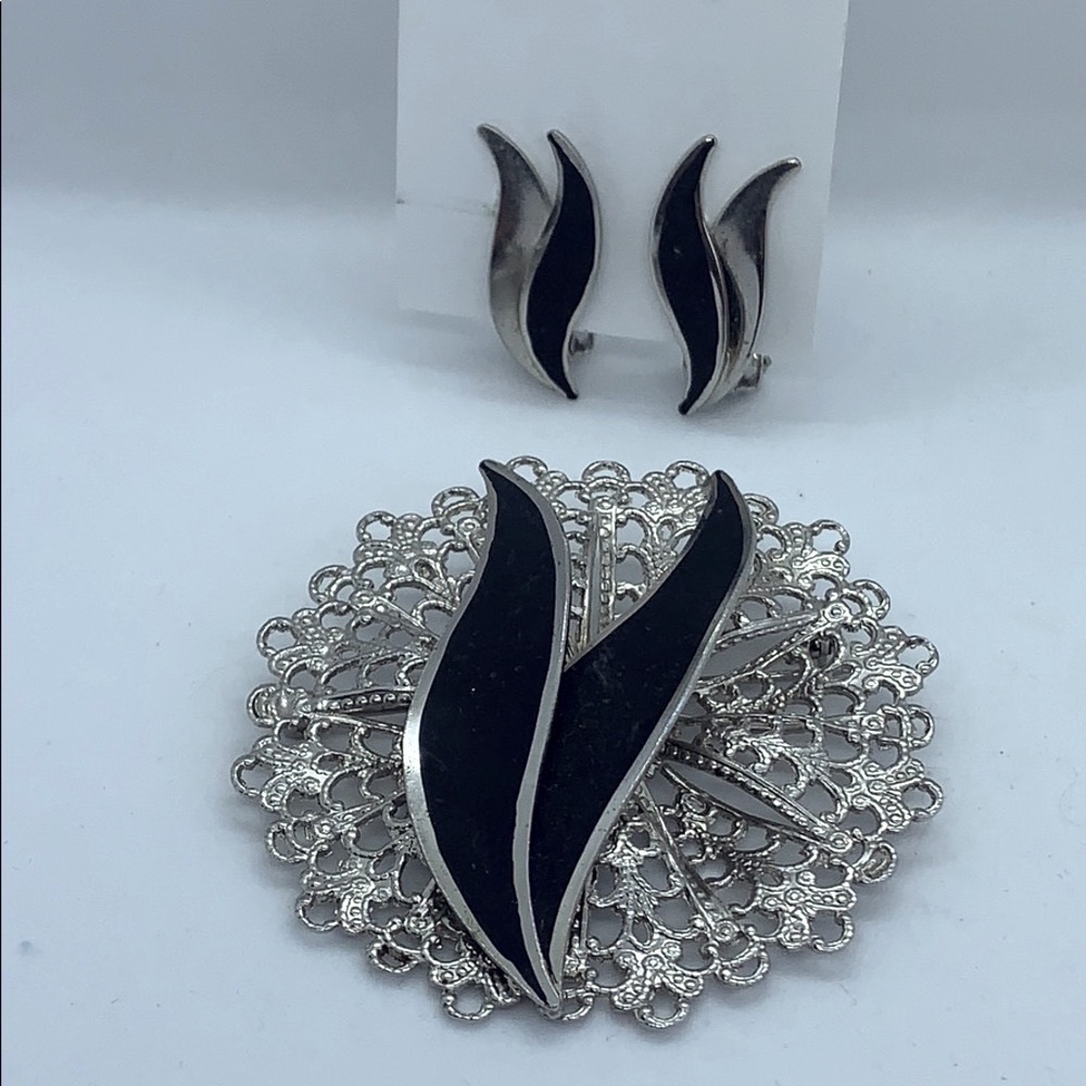 Silver tone with black Art Deco style flames